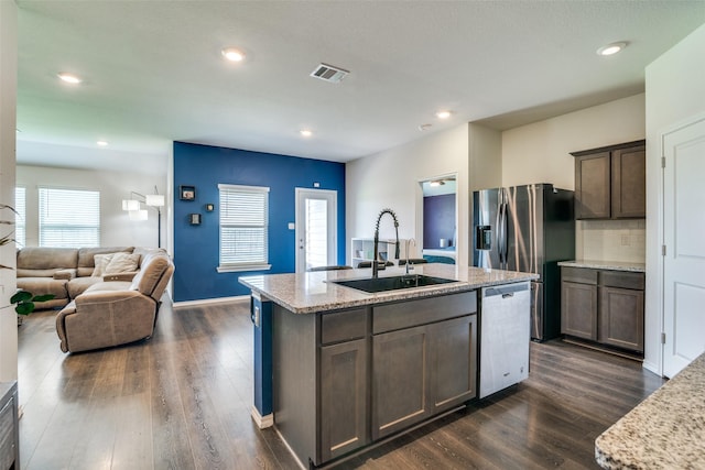 1315 Blessed Ln, Royse City, TX 75189 - kitchen with stainless steel dishwasher, dark wood-type flooring, a kitchen island with sink, recessed lighting, and dark brown cabinets