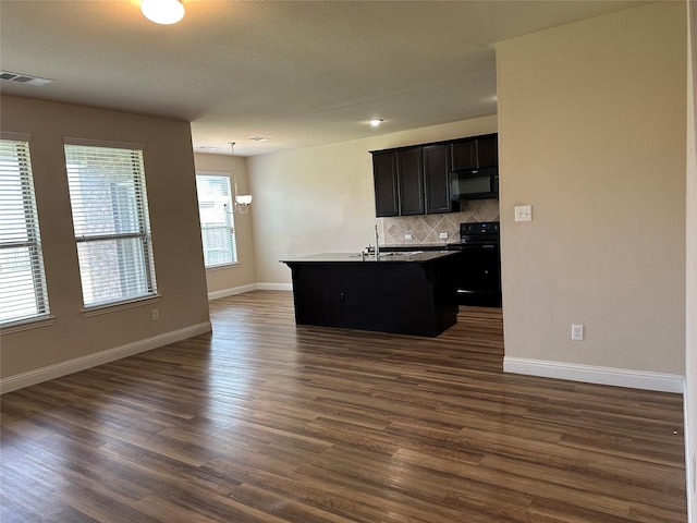 1206 Erika, Forney, TX 75126 - kitchen with black appliances, a breakfast bar area, backsplash, open floor plan, and a kitchen island with sink