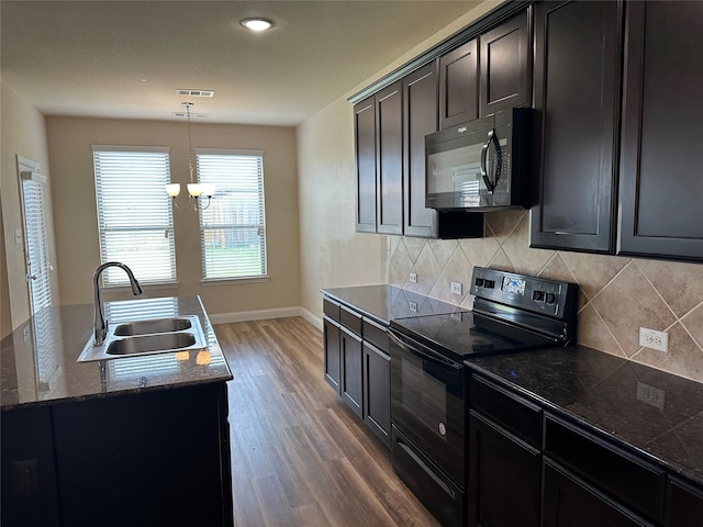 1206 Erika, Forney, TX 75126 - kitchen featuring black appliances, dark wood finished floors, tasteful backsplash, and pendant lighting