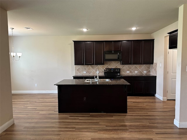 1206 Erika, Forney, TX 75126 - kitchen with black appliances, wood finished floors, tasteful backsplash, dark stone countertops, and recessed lighting