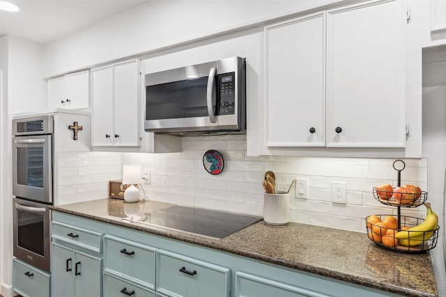 1702 Cheyenne Dr, Richardson, TX 75080 - kitchen featuring stainless steel appliances, white cabinets, tasteful backsplash, dark stone countertops, and blue cabinets