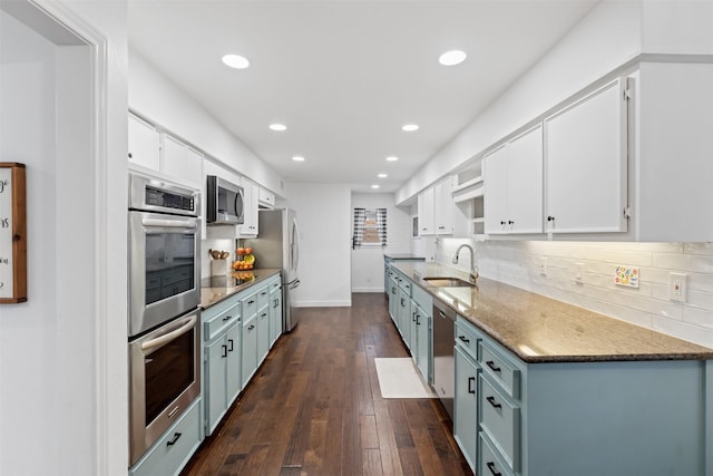 1702 Cheyenne Dr, Richardson, TX 75080 - kitchen featuring appliances with stainless steel finishes, recessed lighting, decorative backsplash, white cabinets, and dark wood-type flooring