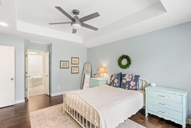 1702 Cheyenne Dr, Richardson, TX 75080 - bedroom with a tray ceiling, dark wood-style flooring, and a ceiling fan