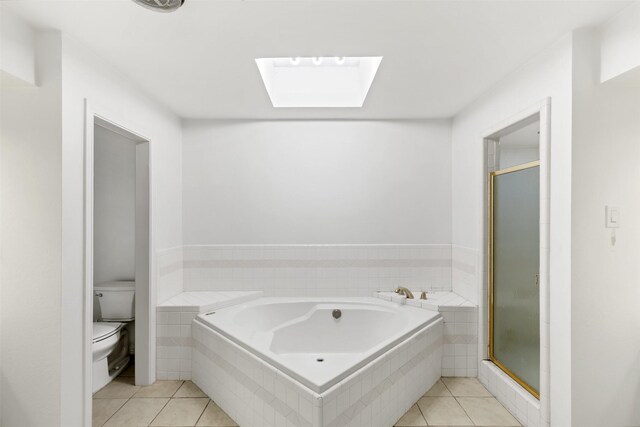 1702 Cheyenne Dr, Richardson, TX 75080 - bathroom featuring a skylight, tile patterned flooring, and a bath