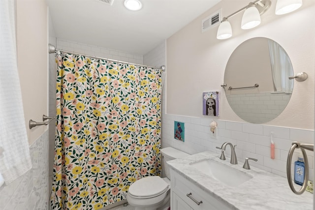 1702 Cheyenne Dr, Richardson, TX 75080 - bathroom featuring tile walls, vanity, a shower with curtain, and wainscoting