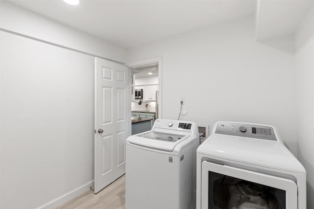1702 Cheyenne Dr, Richardson, TX 75080 - laundry area featuring washer and dryer, light wood finished floors, and recessed lighting