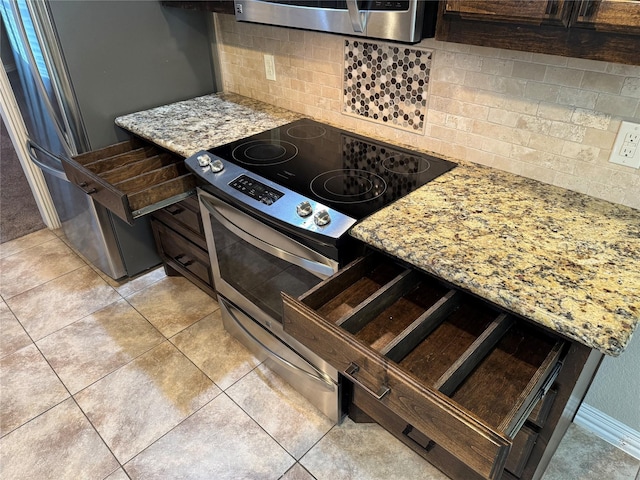 105 Windsor Dr, Forney, TX 75126 - kitchen with appliances with stainless steel finishes, tasteful backsplash, light stone counters, and light tile patterned floors