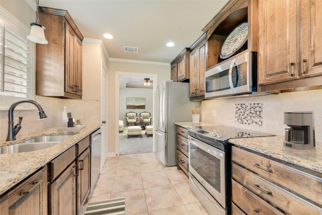 105 Windsor Dr, Forney, TX 75126 - kitchen with stainless steel appliances, light stone counters, tasteful backsplash, a ceiling fan, and hanging light fixtures