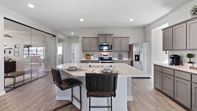 1525 Central Park Dr, Alvarado, TX 76009 - kitchen featuring stainless steel appliances, gray cabinetry, a kitchen island, light countertops, and recessed lighting