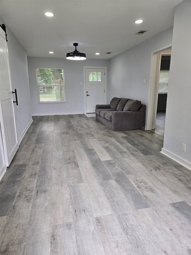 810 Shawnee Trce, Grand Prairie, TX 75051 - living area with wood finished floors, recessed lighting, a barn door, and ceiling fan