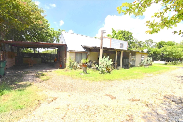 103 One Feather, Whitney, TX 76692 - rear view of property with driveway, a carport, and a metal roof