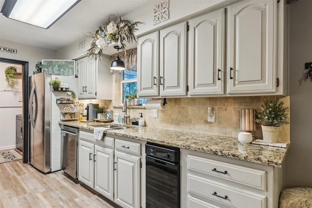 3244 Gail Ct, Irving, TX 75060 - kitchen featuring appliances with stainless steel finishes, light stone countertops, light wood finished floors, and tasteful backsplash