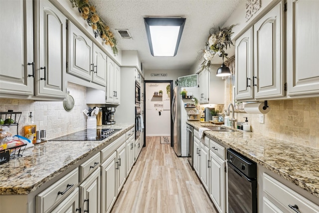 3244 Gail Ct, Irving, TX 75060 - kitchen with stainless steel appliances, decorative backsplash, light wood finished floors, and light stone counters