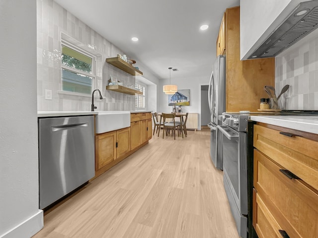 312 Meadowlark Dr, Richardson, TX 75080 - kitchen with custom exhaust hood, stainless steel appliances, brown cabinets, light wood-type flooring, and backsplash