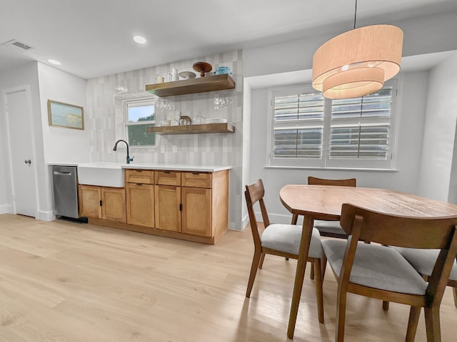 312 Meadowlark Dr, Richardson, TX 75080 - kitchen with stainless steel dishwasher, light wood-style floors, plenty of natural light, backsplash, and recessed lighting