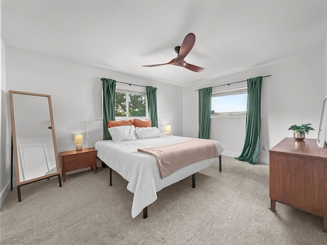 312 Meadowlark Dr, Richardson, TX 75080 - bedroom with multiple windows, light colored carpet, and a ceiling fan