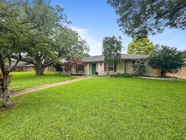 312 Meadowlark Dr, Richardson, TX 75080 - view of front of home with a front yard and brick siding