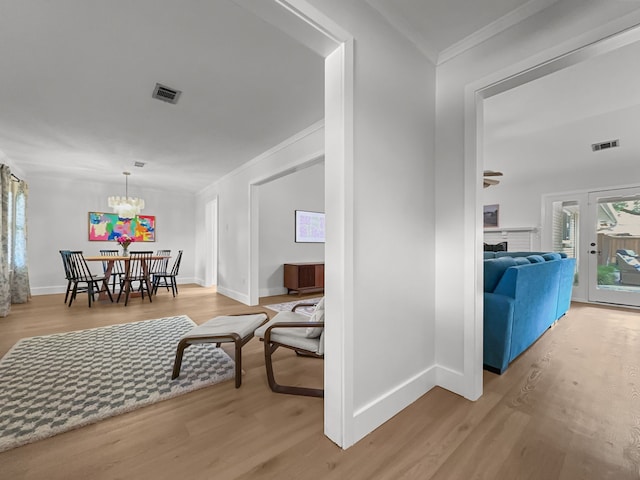 312 Meadowlark Dr, Richardson, TX 75080 - hall with crown molding, wood finished floors, and a chandelier
