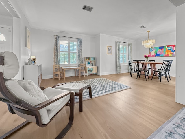 312 Meadowlark Dr, Richardson, TX 75080 - living area featuring a chandelier, wood finished floors, and ornamental molding