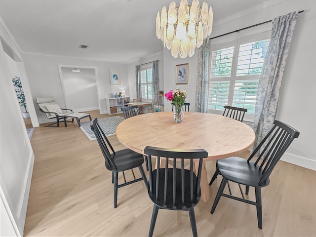 312 Meadowlark Dr, Richardson, TX 75080 - dining space featuring light wood-style flooring, ornamental molding, and a chandelier