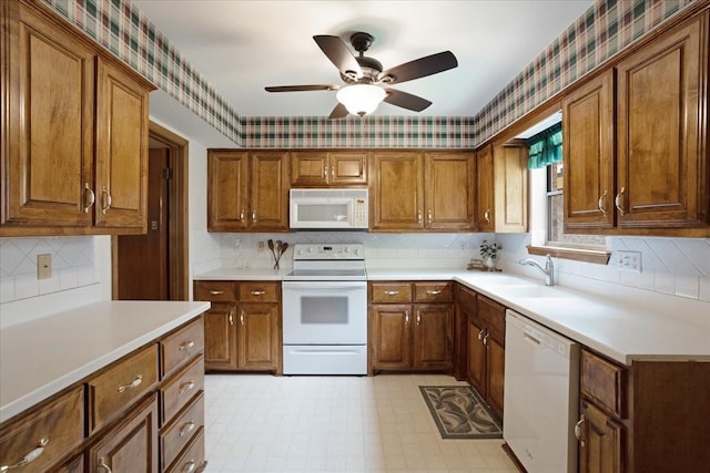 2909 Dover Dr, Sherman, TX 75092 - kitchen featuring white appliances, wallpapered walls, brown cabinetry, and ceiling fan