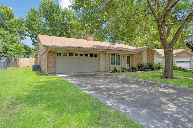 2909 Dover Dr, Sherman, TX 75092 - ranch-style home featuring a chimney, asphalt driveway, an attached garage, brick siding, and board and batten siding