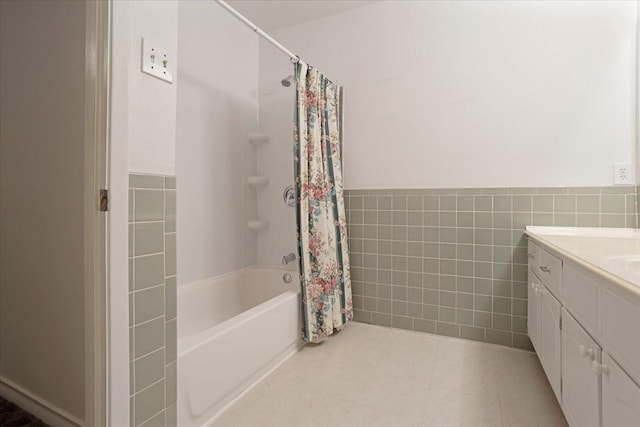 2909 Dover Dr, Sherman, TX 75092 - bathroom featuring tile walls, vanity, shower / bath combo, tile patterned floors, and a wainscoted wall