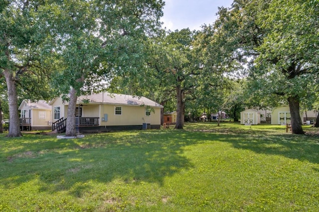 902 Travis Ave, Alvarado, TX 76009 - view of grassy yard with a storage unit