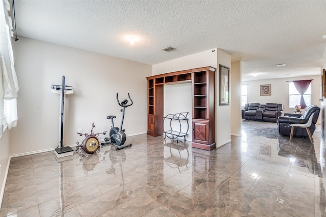 2007 Brazos Ct, Grand Prairie, TX 75052 - exercise area with marble tiled floors and a textured ceiling