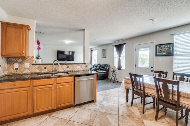 2007 Brazos Ct, Grand Prairie, TX 75052 - kitchen featuring dishwasher, healthy amount of natural light, backsplash, open floor plan, and a textured ceiling