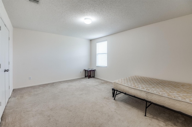 2007 Brazos Ct, Grand Prairie, TX 75052 - unfurnished bedroom featuring light carpet and a textured ceiling