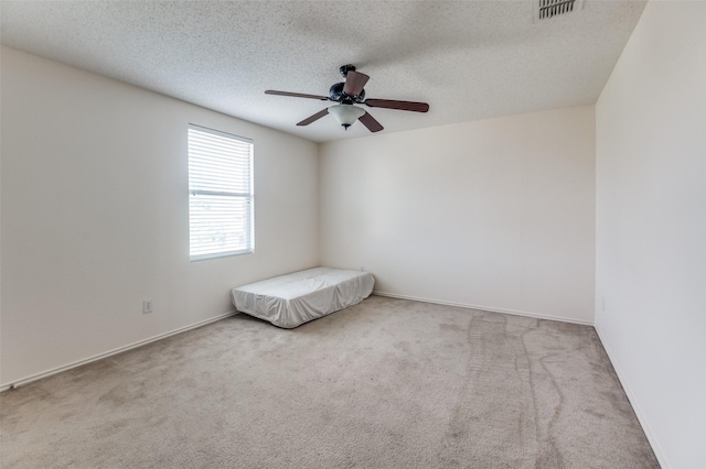 2007 Brazos Ct, Grand Prairie, TX 75052 - empty room featuring carpet, a ceiling fan, and a textured ceiling