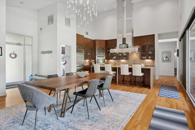 613 N Bailey Ave, Fort Worth, TX 76107 - dining area featuring a high ceiling and light wood finished floors