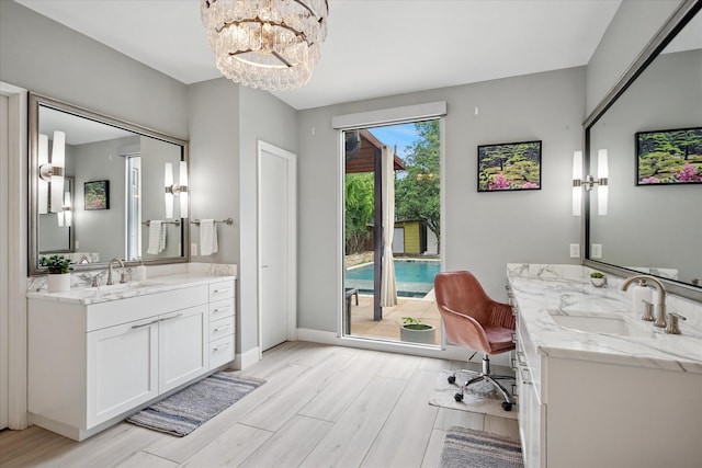 613 N Bailey Ave, Fort Worth, TX 76107 - full bathroom with wood finished floors, two vanities, and a chandelier