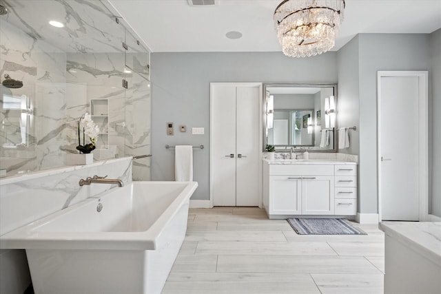 613 N Bailey Ave, Fort Worth, TX 76107 - full bathroom with a chandelier, a soaking tub, a marble finish shower, and vanity