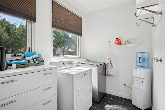 613 N Bailey Ave, Fort Worth, TX 76107 - washroom with washer and clothes dryer, dark tile patterned flooring, and plenty of natural light