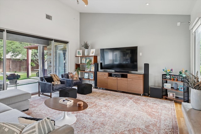 613 N Bailey Ave, Fort Worth, TX 76107 - living room with plenty of natural light, wood finished floors, and a high ceiling