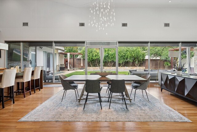 613 N Bailey Ave, Fort Worth, TX 76107 - dining area with a towering ceiling and wood finished floors