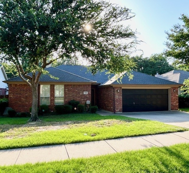 3900 Chimney Rock Dr, Denton, TX 76210 - ranch-style home featuring a garage, driveway, a front yard, brick siding, and roof with shingles