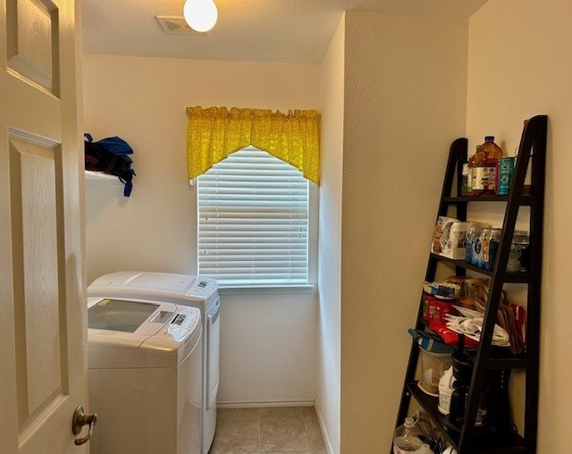 3900 Chimney Rock Dr, Denton, TX 76210 - laundry area with washing machine and clothes dryer and light tile patterned floors