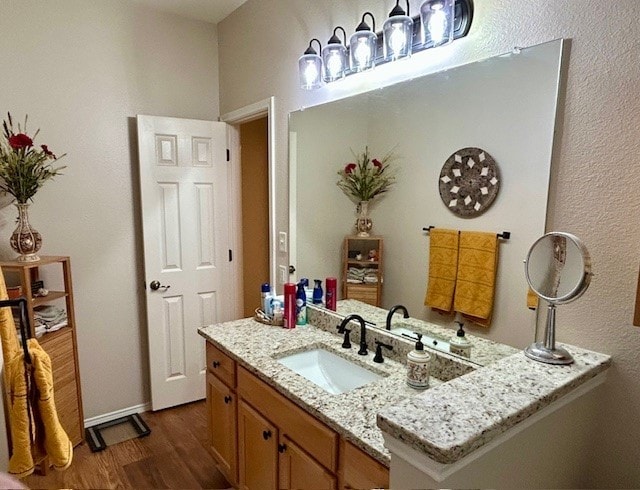 3900 Chimney Rock Dr, Denton, TX 76210 - bathroom with wood finished floors and vanity