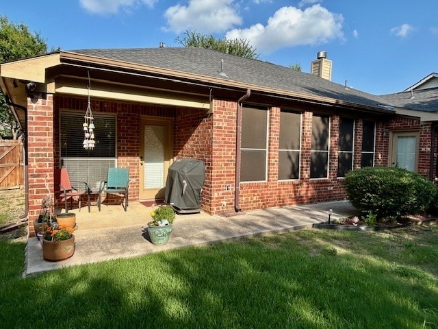 3900 Chimney Rock Dr, Denton, TX 76210 - back of house featuring brick siding, a chimney, a patio area, and roof with shingles