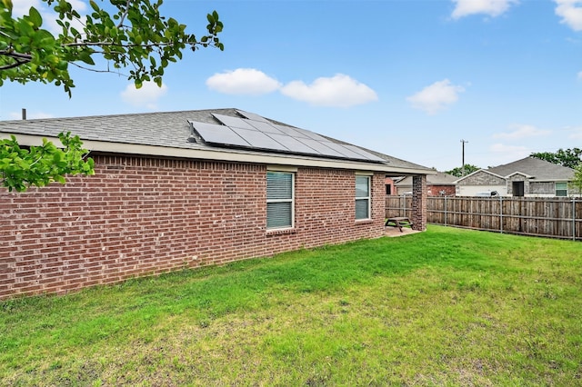 2806 Peony Dr, Sherman, TX 75092 - back of house featuring solar panels, a fenced backyard, and brick siding