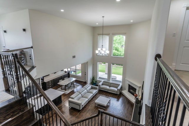 13122 Dolomite Dr, Frisco, TX 75035 - living room with plenty of natural light, wood finished floors, recessed lighting, a chandelier, and a towering ceiling