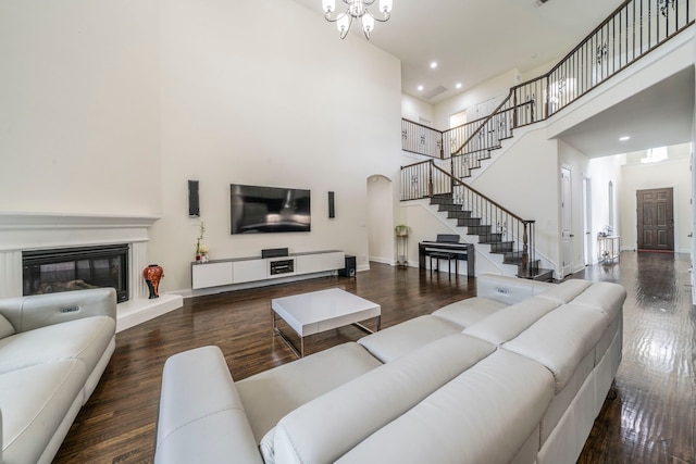 13122 Dolomite Dr, Frisco, TX 75035 - living area with a towering ceiling, stairway, wood finished floors, recessed lighting, and a chandelier