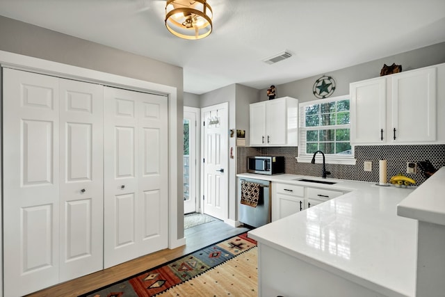 104 Nob Hill Cir, Malakoff, TX 75148 - kitchen featuring stainless steel appliances, light wood-type flooring, light countertops, and tasteful backsplash