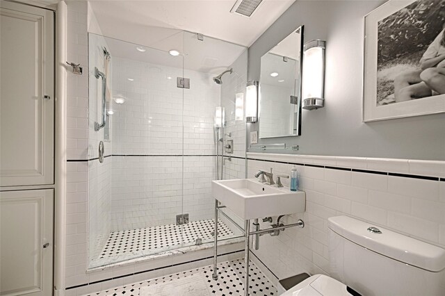 3525 Turtle Creek Blvd Unit 4E, Dallas, TX 75219 - full bath with a shower stall, tile walls, and wainscoting