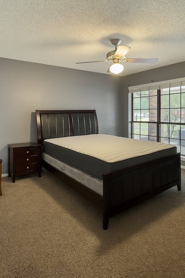 202 Modene Ave, Waxahachie, TX 75165 - carpeted bedroom with a textured ceiling and ceiling fan