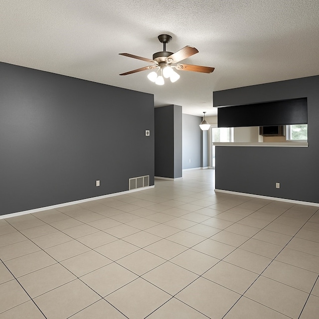 202 Modene Ave, Waxahachie, TX 75165 - unfurnished living room with ceiling fan and a textured ceiling