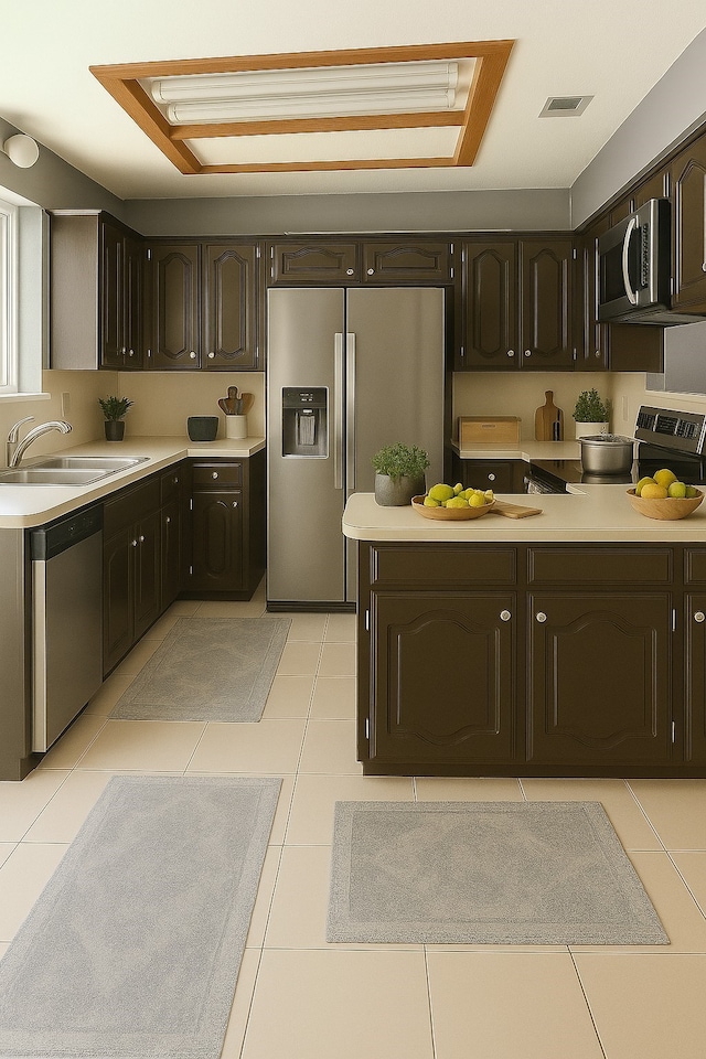 202 Modene Ave, Waxahachie, TX 75165 - kitchen with appliances with stainless steel finishes, dark brown cabinetry, light countertops, and light tile patterned floors